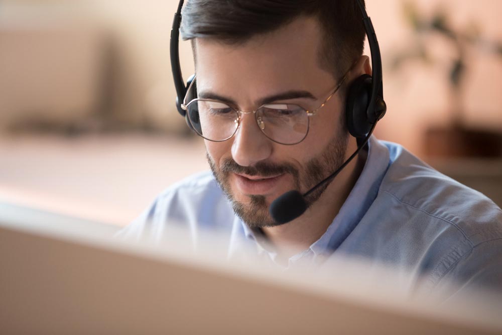 Focused businessman telemarketer telesales agent wear wireless headset make conference video call