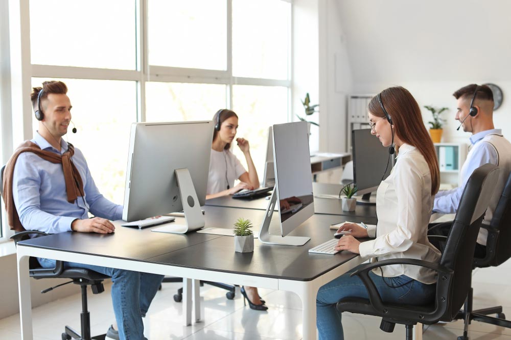 Team of technical support agents working in office